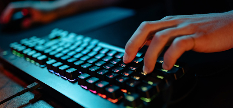 Gamer using keyboard at night