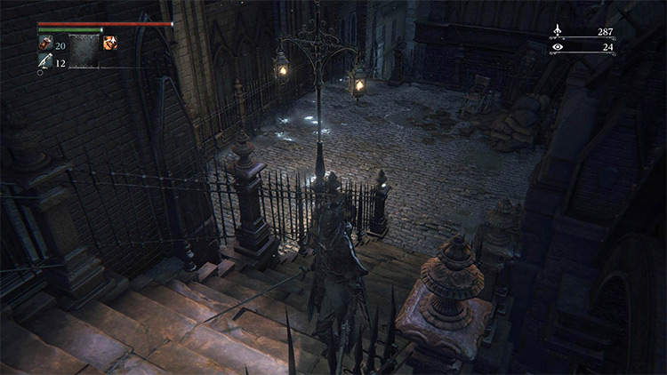 The small courtyard, with the stairs that lead to the warehouse at the far end / Bloodborne