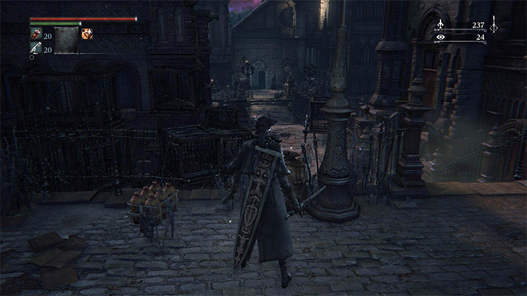 The area full of dog cages, with the warehouse entrance in the distance / Bloodborne
