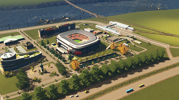 Buildings that draw a lot of people, like this mall and stadium, are well served by having access to both the highway and railway. / Cities: Skylines